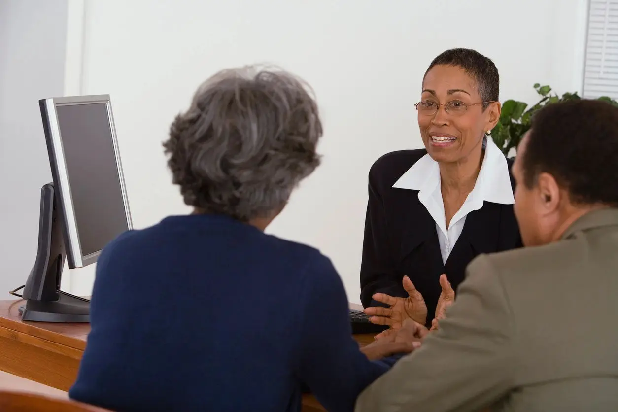 Advisor consulting couple at office desk Advisor consulting couple at office desk